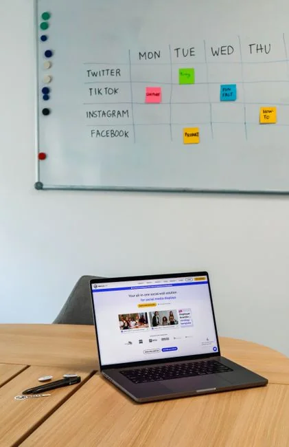 Person using smartphone for stock market analysis at home office.